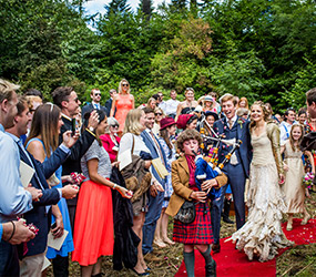 Bag piper leads a wedding procession at Fingask Castle