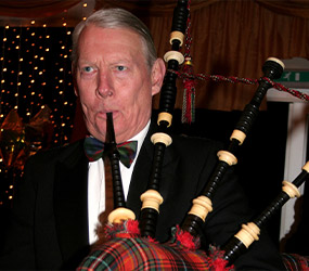 A bag piper plays in the Fingask Pavilion