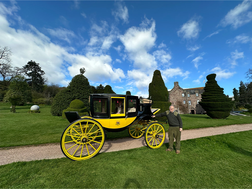 Andrew Threipland standing next to the Fingask Castle Coach