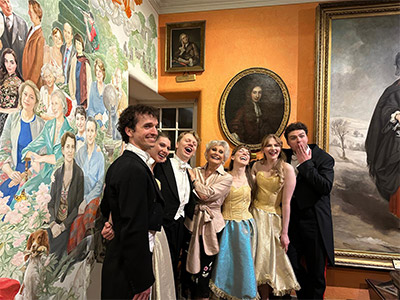 Fingask Follies 28th season cast agains mural backdrop